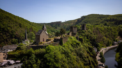 Aerial view of Esch-sur-Sure, medieval town in Luxembourg, dominated by castle, canton Wiltz in Diekirch. Forests of Upper-Sure Nature Park, meander of winding river Sauer, near Upper Sauer Lake.