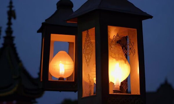 Close-Up of Two Ornate Lanterns with Glowing Lights in the Evening Dusk