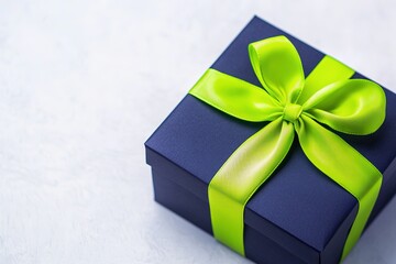 Blue gift box with vibrant green ribbon on soft background