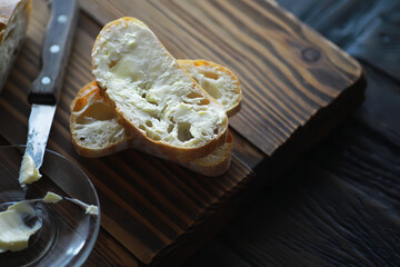 Freshly Buttered Bread Slices on Wooden Cutting Board with Knife - Rustic Breakfast Setting