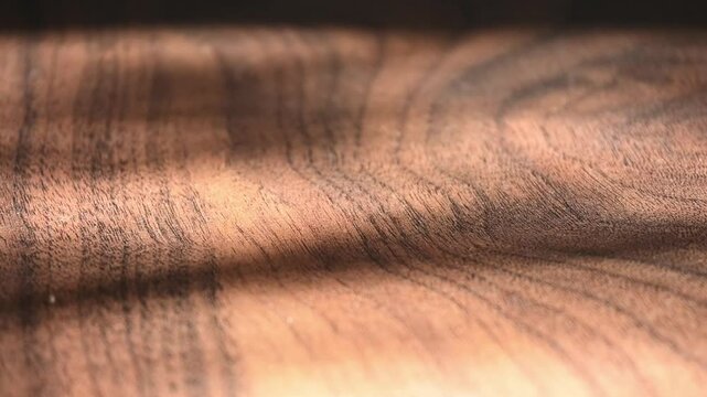 Close up view of wooden laminate floor with moving shadows
