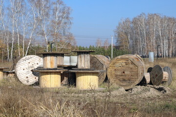 Obraz premium Wooden cable drums on an autumn day in the open air