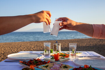 People Toasting with Turkish Raki at a Traditional Dinner