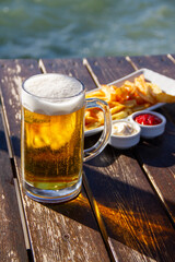 Beer Glass, French Fries, Ketchup, Mayonnaise on Wooden Table