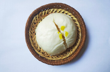 Delicious stuffed steamed bun n plate isolate on a white backdrop.