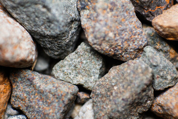 Close Up of Gray gravel stones for the construction industry. Gravel stones near the railway track. Texture. Background
