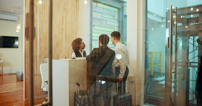 Business, people and luggage at reception of hotel for booking, luxury hospitality and concierge service. Men, talking and receptionist of resort schedule, room availability and reservation check in