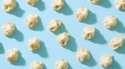 overhead view of Baozi ,asian dumplings, dim sum, ravioli, buuz, pelmeni, pyanse, khinkali or manti isolated on blue background, concept for cooking