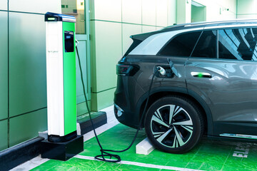 Charging a car battery in a city house parking lot.