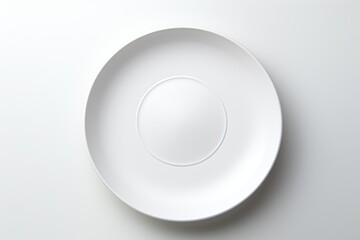 A simple white plate viewed from above, emphasizing minimalism and elegance.