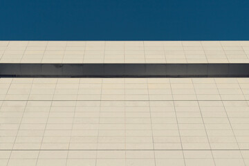 Abstract architecture. Close up of a  building facade with blue sky.