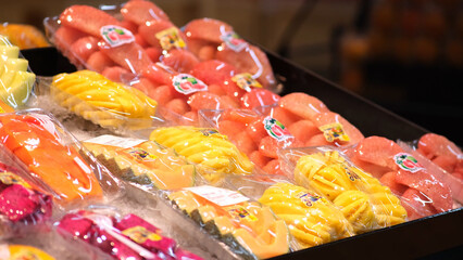 A close-up of exotic fruits displayed on supermarket shelves, showcasing vibrant colors and unique textures. This scene highlights the appeal of healthy, adventurous eating and culinary exploration.