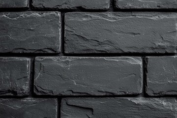 Textured black brick wall, ideal for backgrounds and design purposes.