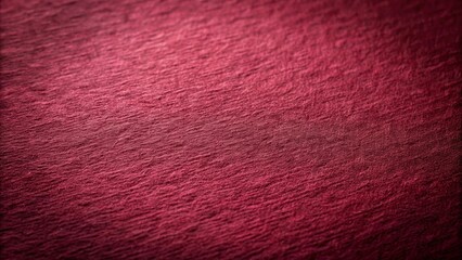 A Close-Up View of Deep Crimson Fabric with a Subtle Textured Surface and a Gradual Shift in Light