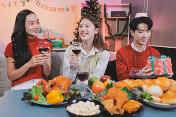 Friends opening Christmas gifts in living room
