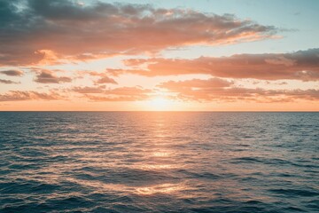 Obraz premium A serene sunset scene over the ocean on a cloudy day, perfect for travel or nature-themed projects. Beautiful simple AI generated image
