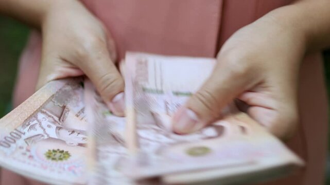 Thai Baht Money Count, Close-up Thai Baht Banknotes in Hand, Business hands Counting Money, Money and financial concepts