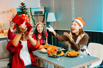 Holiday spirit with Asian friends exchanging gifts, sharing laughs, and enjoying a festive Christmas dinner