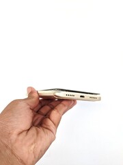 Male hand holding a broken Android cellphone on a white background