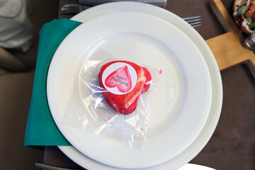 Red donut on a plate with the inscription "birthday party"