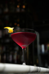 Cosmopolitan Martini cocktail glass on a marble table background with copy space, close-up