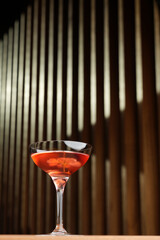Cocktail with peach liqueur, wine and vanilla flower petals.