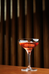 Cocktail with peach liqueur, wine and vanilla flower petals.