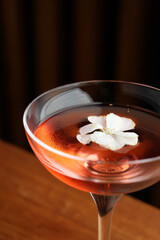 Cocktail with peach liqueur, wine and vanilla flower petals.