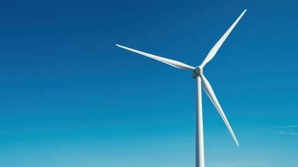 Fototapeta premium A solitary wind turbine against a clear blue sky, symbolizing renewable energy and sustainable practices.