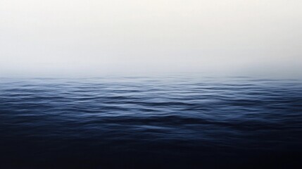 Obraz premium Calm sea surface with gentle waves, serene and tranquil atmosphere, soft gradient sky.