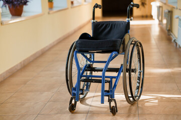 A Solitary Blue Wheelchair in a Brightly Lit Hallway
