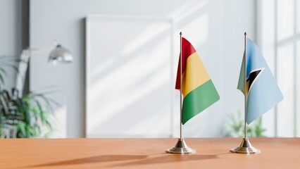 FLAGS OF GUINEA And SAINT LUCIA ON TABLE