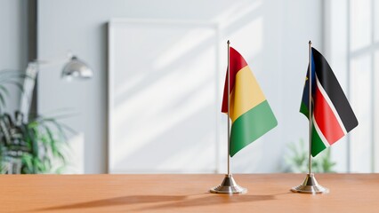 FLAGS OF GUINEA And SOUTH SUDAN ON TABLE
