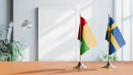 FLAGS OF GUINEA-BISSAU And SWEDEN ON TABLE