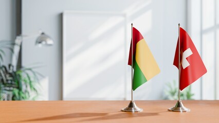 FLAGS OF GUINEA-BISSAU And SWITZERLAND ON TABLE