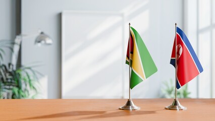 FLAGS OF GUYANA And KOREA NORTH ON TABLE