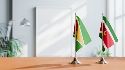 FLAGS OF GUYANA And SURINAME ON TABLE