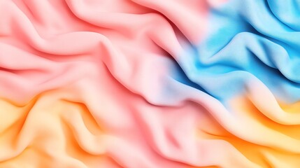 Obraz premium Abstract colorful fabric with gradient hues of pink, blue, and orange, showcasing soft folds and gentle textile texture