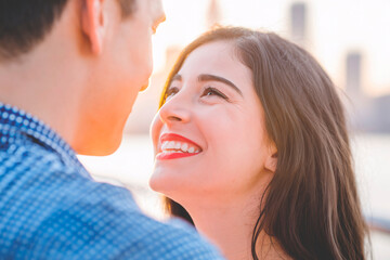 Fototapeta premium Genuine Love and Joy at Sunset. Intimate close-up portrait captured during golden hour showing genuine emotions between a couple.