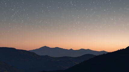 A panoramic view of a mountain range at dusk with a clear starry sky.