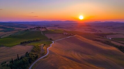 Magical sunset and rural landscape view of Picturesque agrotourism with characterized green top hill farms of olive groves and vineyards typical curved road with cypress at Crete Senesi in Toscana, It