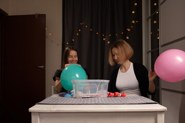 Women Blowing Up Balloons for Party Decoration, inflating colorful balloons for a joyful event,...