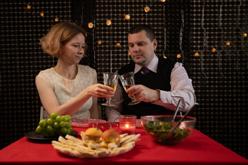 Romantic Dinner, husband and wife celebrating marriage, romantic evening at restaurant, couple sharing wine and food