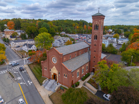 St Patrick Parish church aerial view at 1 Cross Street in fall with foliage in historic village of Whitinsville, town of Northbridge, Massachusetts MA, USA. 