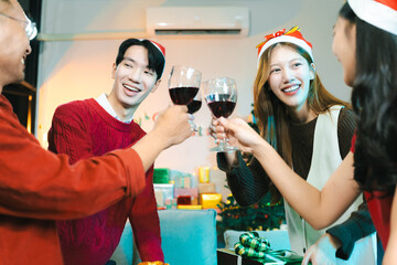 Dinner and group of people celebrating together at Merry Christmas & Happy New Year. Friends are happy and celebrating with food, wine and friendship of love and gift exchange at the event.