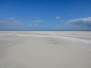very large beach with smooth sand in the sunshine