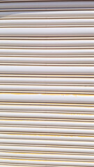 Obraz premium close- view a white metal roll- door with rust spots