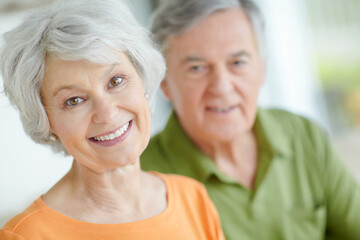 Senior couple, relax and portrait with smile in home for retirement, connection and romantic bonding. Elderly woman, man and face with support in house for peace, marriage or love on weekend together