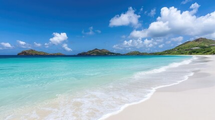 Obraz premium Sparkling ocean waves with clean white sand beach, clear blue water