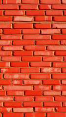 Obraz premium close- a red brick wall with a textured surface